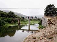 The bridge built by Father, his Brother, and Father's First Son, with distant relatives from the Low clan